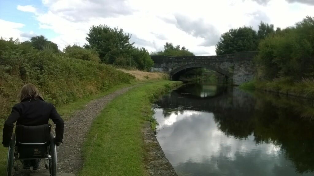 Inclusive Walks with Experience Community Post image 2 A wheelchair user on the Calder Hebble Canal.