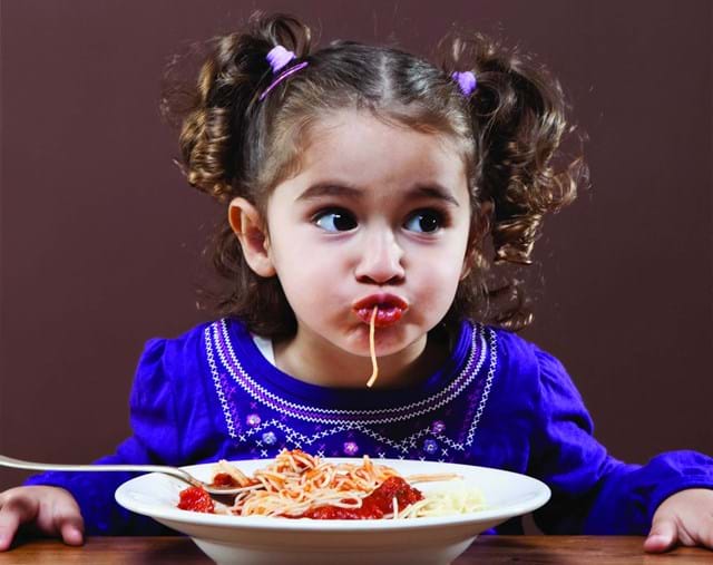 Image name child eating spaghetti the 1 image from the post Multigenerational Getaways in Yorkshire.com.