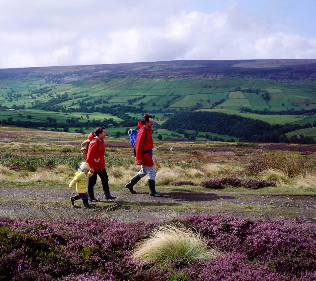 Top 10 On Foot Experiences Post image 1 Image name family walking on track near blakey the 1 image from the post Top 10 On Foot Experiences in Yorkshire.com.