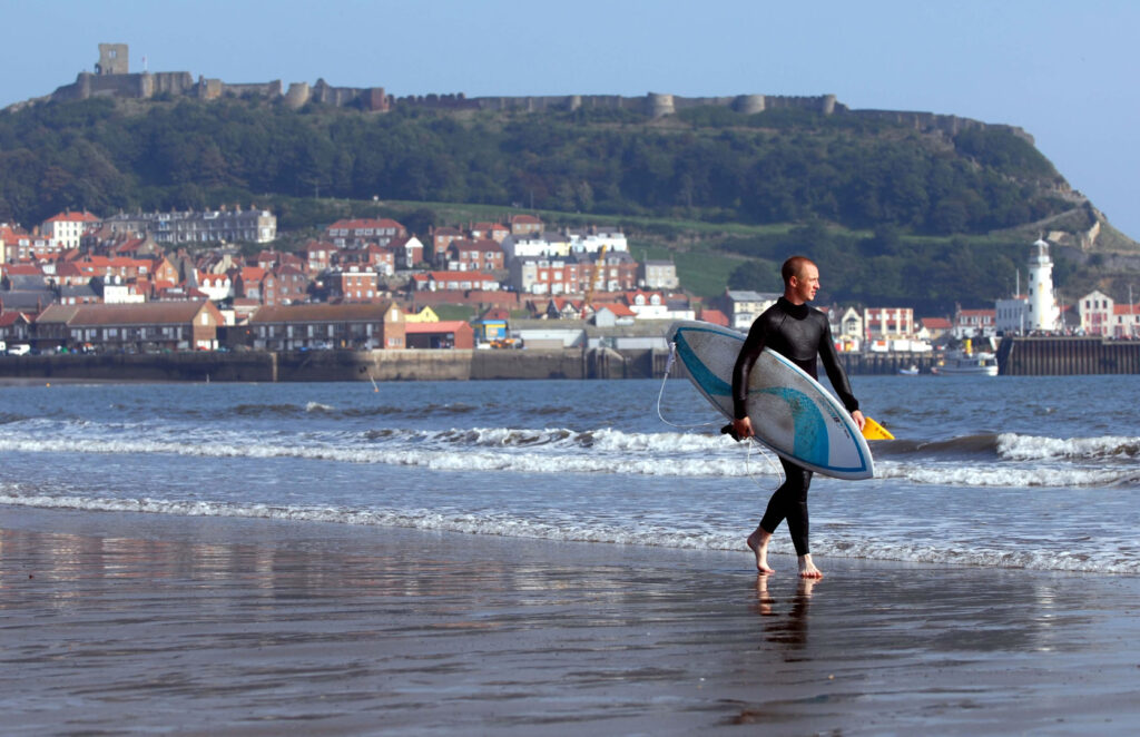 Scarborough Page image 17 Surfer carrying surf board at South Bay Scarborough