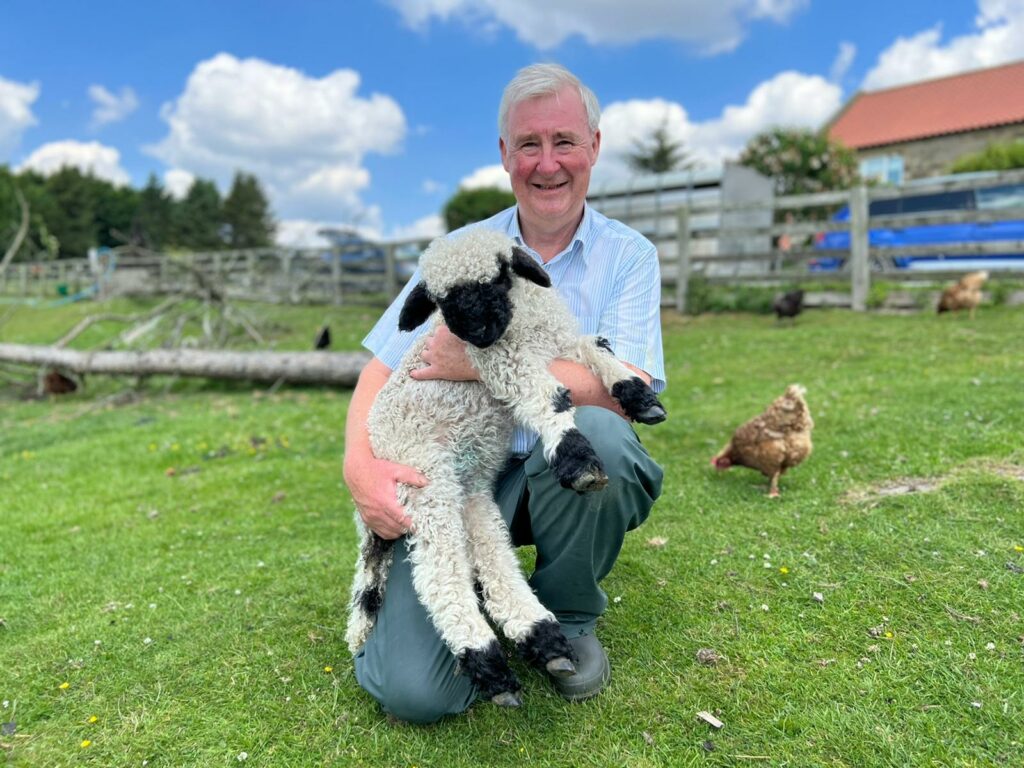 Book Giveaway: "The Tales and Tails of a Yorkshire Vet" by Peter Wright Page image 5 Image name 7 Peter with a Valais Blacknose lamb ©Peter the 5 image from the post Book Giveaway: "The Tales and Tails of a Yorkshire Vet" by Peter Wright in Yorkshire.com.