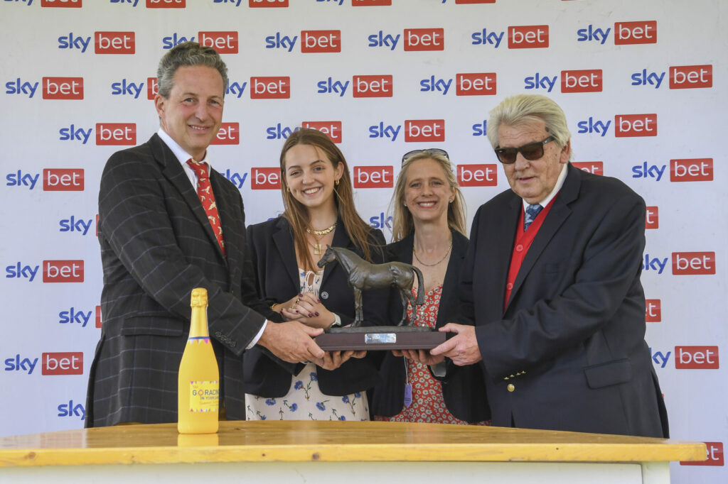 Festival Fun For Fahey Press Release image 2 Picture 1 shows Robin O’Ryan receiving the Byerley Turk Trophy for leading trainer of the week on behalf of Richard Fahey, from Mark, Clare and Charlotte Oglesby of Goldsborough Hall.