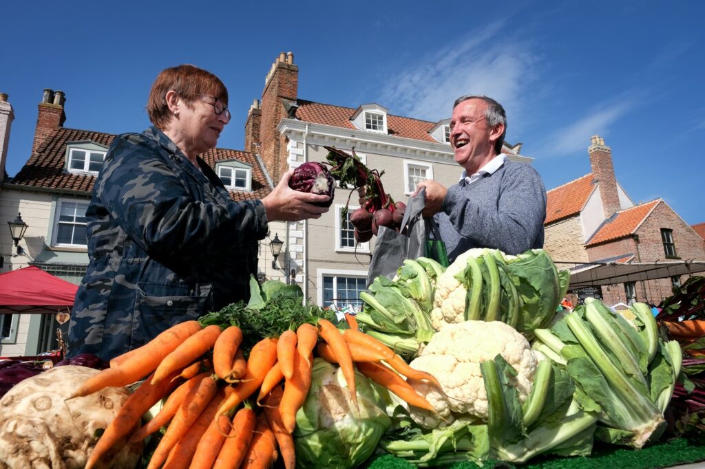 Shopping in Malton - For Locals & Visitors Page image 4 Image name Greengrocer Stall MMFM 2022 laughing malton yorkshire the 2 image from the post Shopping in Malton - For Locals & Visitors in Yorkshire.com.