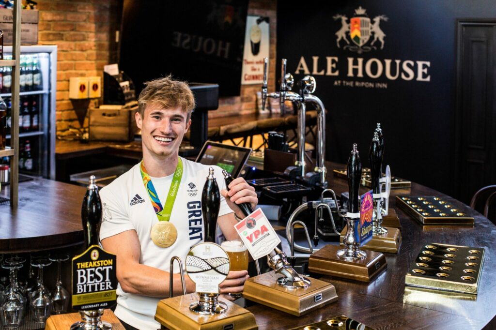 THE INN COLLECTION GROUP PRESS RELEASE - Olympic champion Jack dives "inn" to mark Ripon re-opening Press Release image 7 Image name The Ripon Inn. Jack Laugher pint pull the 7 image from the post THE INN COLLECTION GROUP PRESS RELEASE - Olympic champion Jack dives "inn" to mark Ripon re-opening in Yorkshire.com.