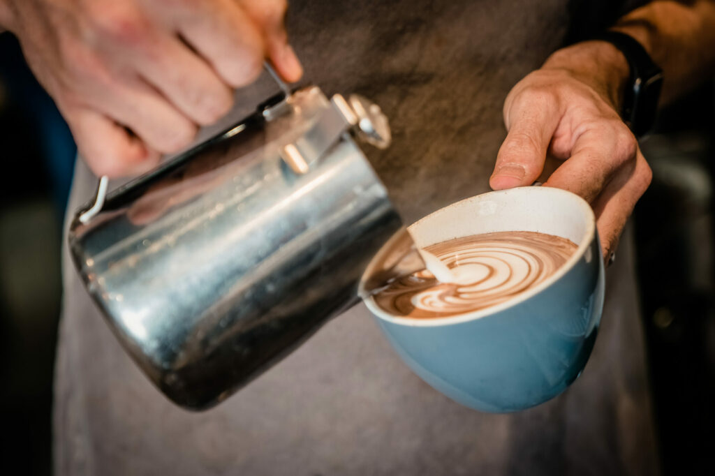 The Best Spots to Sip Coffee - Cafes in Yorkshire Post image 6 Image name pouring steamed milk into coffee curious coffee easingwold yorkshire the 6 image from the post The Best Spots to Sip Coffee - Cafes in Yorkshire in Yorkshire.com.
