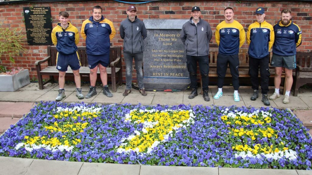 Yorkshire-Grown Plants To Honour Rugby Legend Post image 2 Image name 190624 James Tolson and Carl Riley with Leeds Rhinos grounds team and the finished memorial bed the 1 image from the post Yorkshire-Grown Plants To Honour Rugby Legend in Yorkshire.com.