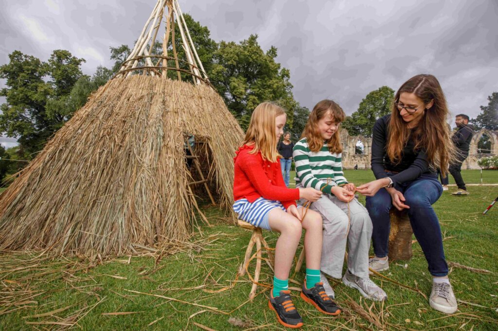 Britain's Ancient Past: Reconstructing a Mesolithic House at the Yorkshire Museum Post image 8 Image name Dr Jess Bates University of York with L Elizabeth and Eleanor Grahame Clarke at the Mesolithic build 14 the 8 image from the post Britain's Ancient Past: Reconstructing a Mesolithic House at the Yorkshire Museum in Yorkshire.com.