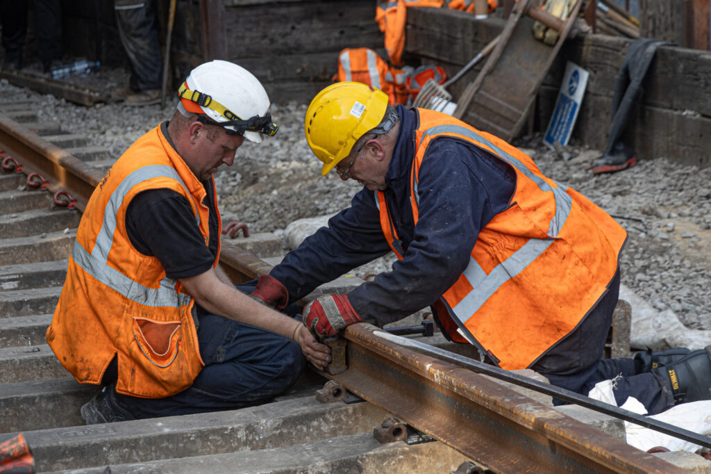 Keighley & Worth Valley Railway Completes £1.25 Million Bridge Replacement Project Post image 6 Image name KWVR Bridge 27 Volunteer Father and Son Andy and Alex Simkins fasten a fishplate in place joining the new track the 6 image from the post Keighley & Worth Valley Railway Completes £1.25 Million Bridge Replacement Project in Yorkshire.com.