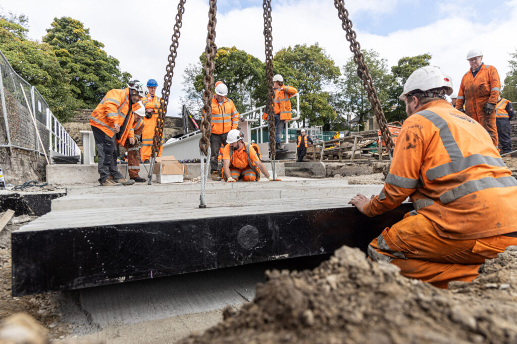 Keighley & Worth Valley Railway Completes £1.25 Million Bridge Replacement Project Post image 2 Image name KWVR Bridge 27 Volunteers line up the concrete pad at the south end of the new bridge the 2 image from the post Keighley & Worth Valley Railway Completes £1.25 Million Bridge Replacement Project in Yorkshire.com.