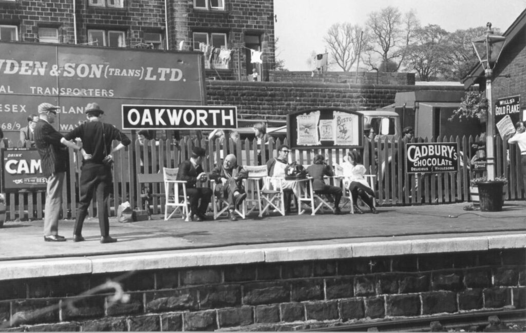 Behind the Scenes with the KWVR Grand Tour: Steam Engines and Classic Cinematic History Post image 2 Image name KWVR Oakworth Station during Railway Children filming 1970 Copyright Robin Higgins and KWVR Archive the 2 image from the post Behind the Scenes with the KWVR Grand Tour: Steam Engines and Classic Cinematic History in Yorkshire.com.