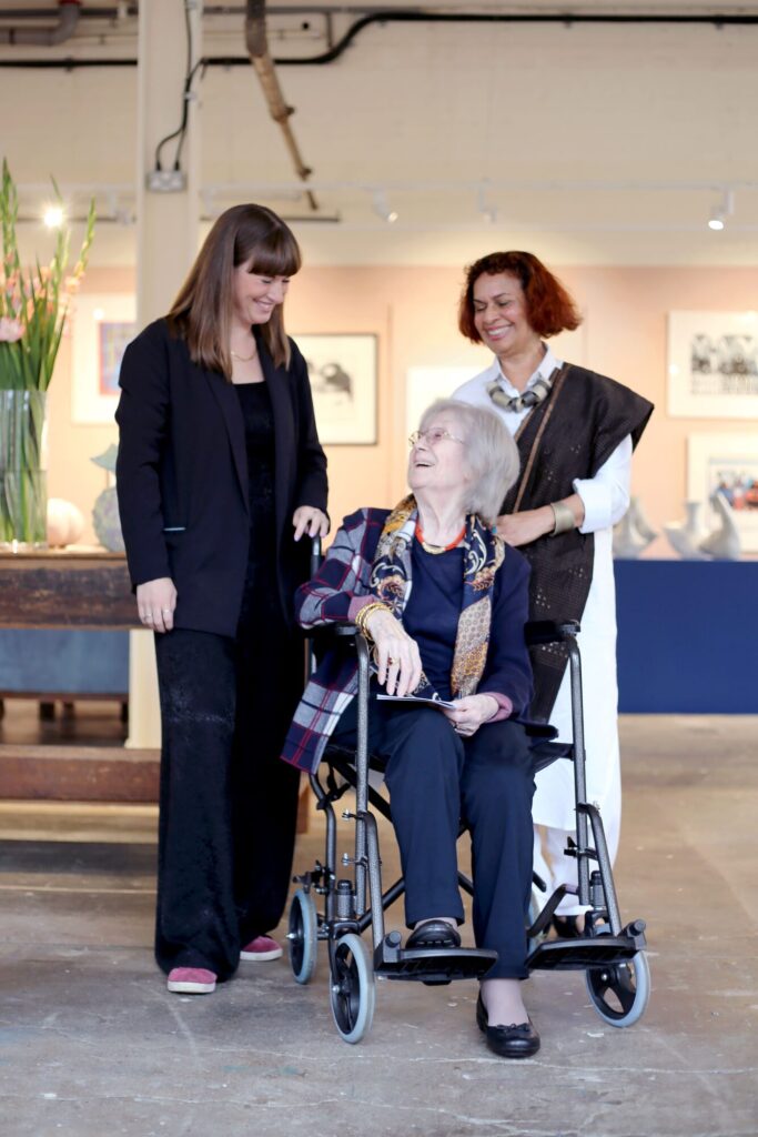 Yorkshire Artists Loretta Braganza and Sheila El-Hassani Present Unique Works at Sunny Bank Mills Exhibition Post image 1 Image name Sunny Bank Mills Arts Director Anna Turzynski left Sheila El Hassani seated Loretta Braganza resized the 1 image from the post Yorkshire Artists Loretta Braganza and Sheila El-Hassani Present Unique Works at Sunny Bank Mills Exhibition in Yorkshire.com.
