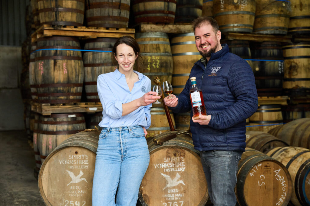 Image name 120225 Jenni Ashwood and Joe Clark with Filey Bay Orange Wine Barrique the 1 image from the post What makes the new Filey Bay Orange Wine Barrique whisky from Yorkshire so special? in Yorkshire.com.