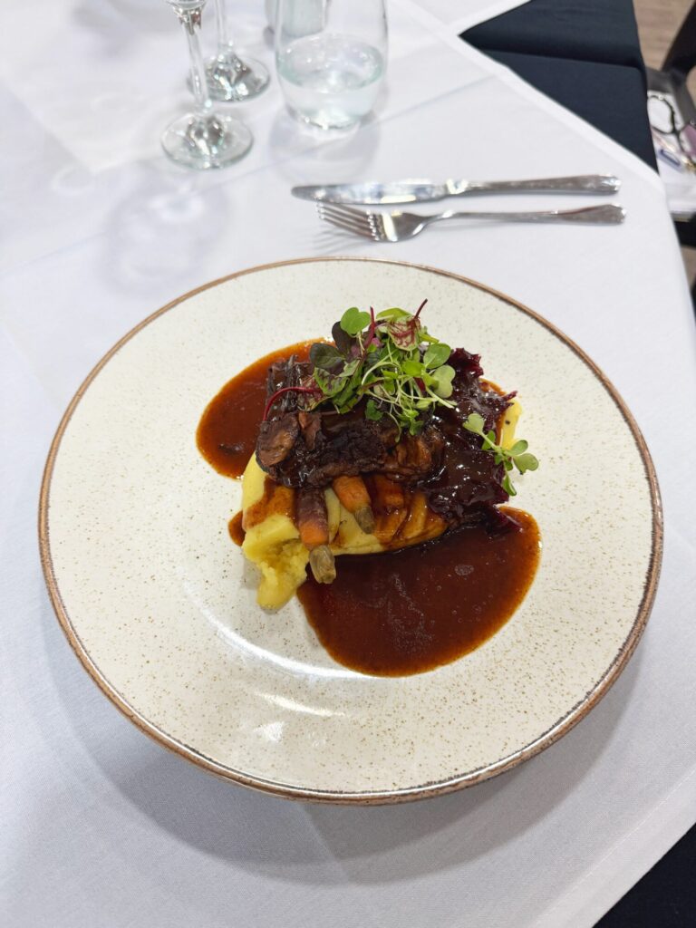 Image name Braised Yorkshire reared British Wagyu Short Rib with creamed Mashed Potato Baby Rainbow Carrots Braised Red Cabbage and Beef Stock Gravy the 3 image from the post The Deep Teams Up with Yorkshire’s Award-Winning Caterer, Shoot the Bull in Yorkshire.com.
