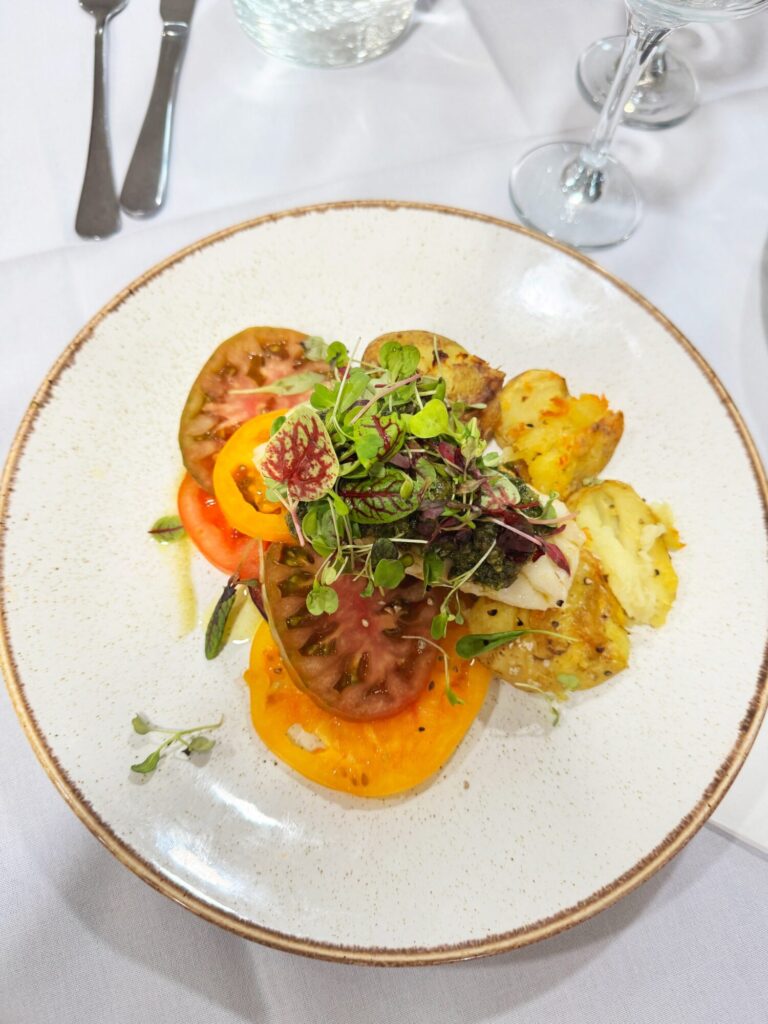 Image name Roasted Cod Loin with Crushed New Potatoes Salsa Verde and Yorkshire Heritage Tomato Salad the 1 image from the post The Deep Teams Up with Yorkshire’s Award-Winning Caterer, Shoot the Bull in Yorkshire.com.