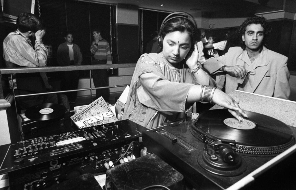 Image name 26410 Rani Kaur aka Radical Sister DJing in the early 1990s. Photo by Tim Smith 1725 3 7 Tim Smith 1 the 8 image from the post Bradford 2025: What Were The Secret Daytimer Parties For South Asian Youth In The 1980s? in Yorkshire.com.
