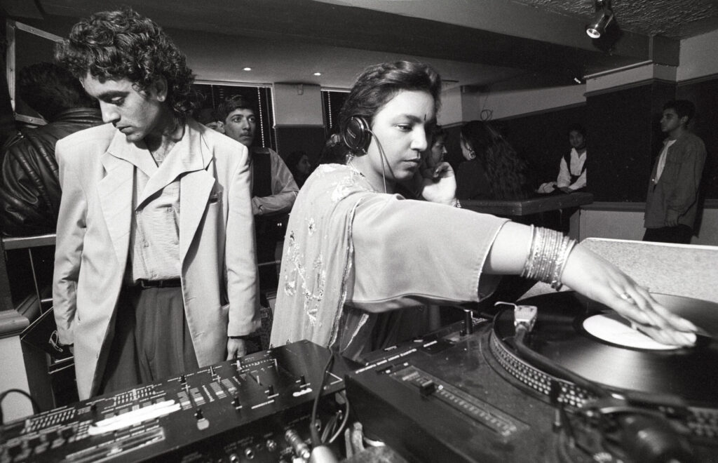 Image name 26411 Rani Kaur aka Radical Sister DJing in the early 1990s. Photo by Tim Smith. Daytimer 1725 2 7 Tim Smith 1 the 9 image from the post Bradford 2025: What Were The Secret Daytimer Parties For South Asian Youth In The 1980s? in Yorkshire.com.